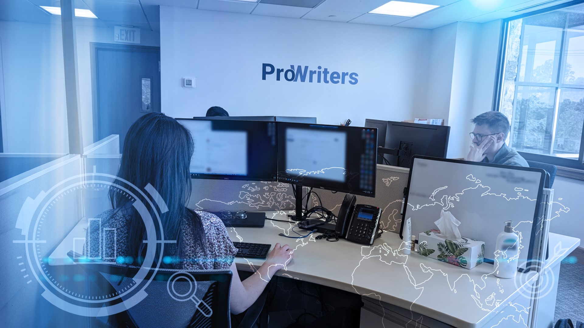 Brokers on their computers in office discussing Cyber Insurance for contractors.