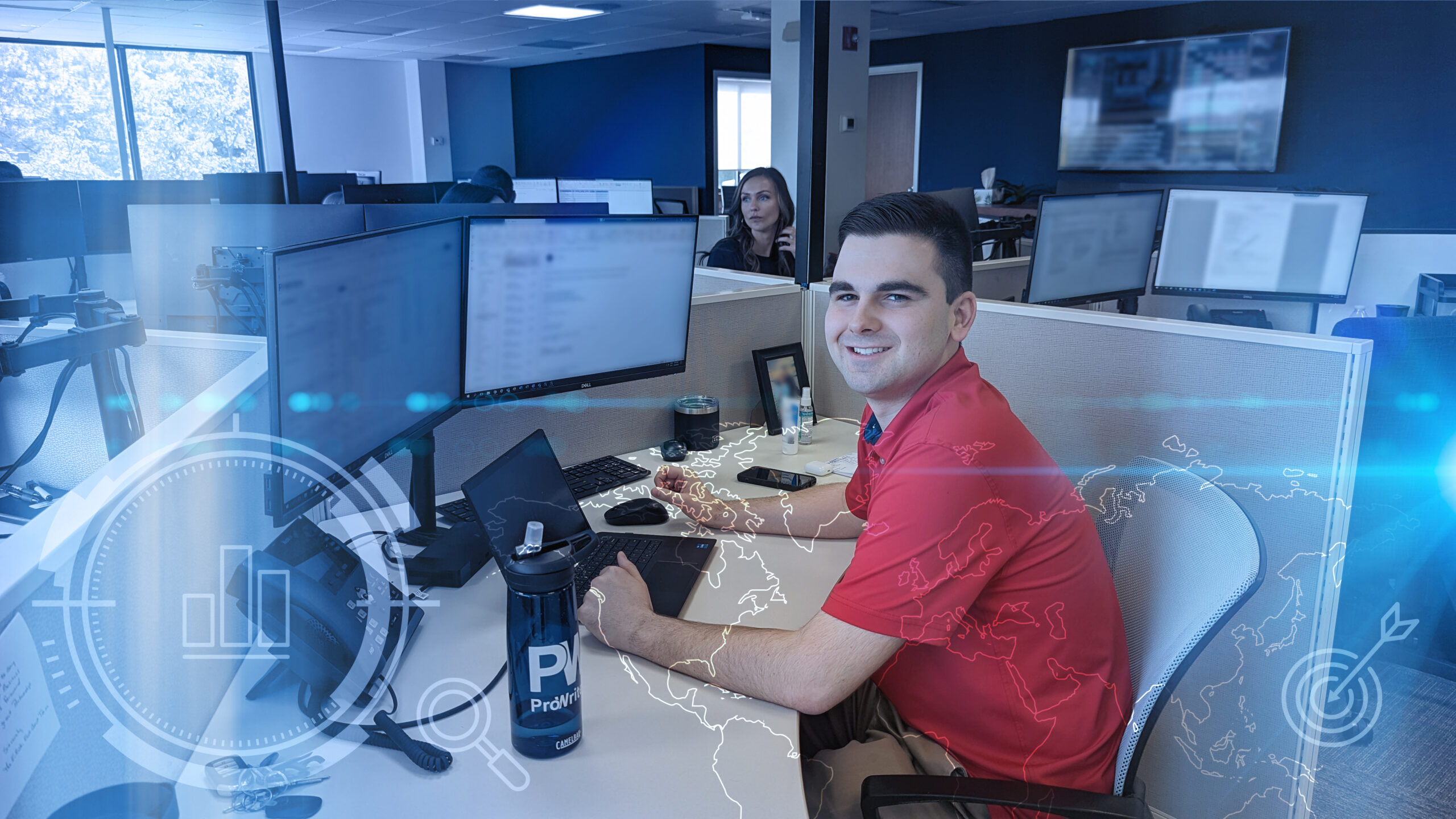Cyber Liability Insurance broker sits at computer in office cubicle, ready to advise clients on Cyber policies.
