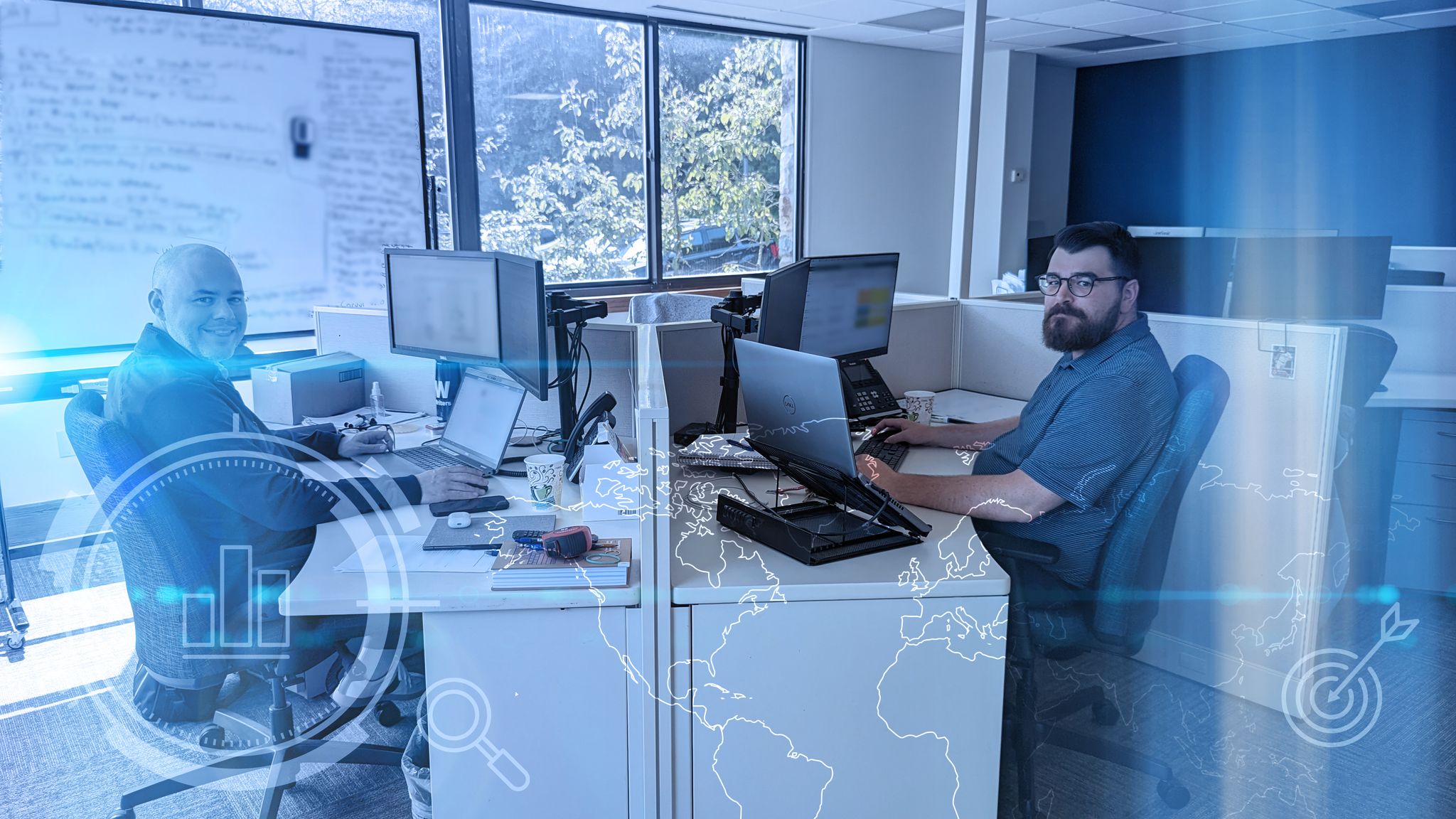 Two ProWriters insurance agents happily working from office desks.
