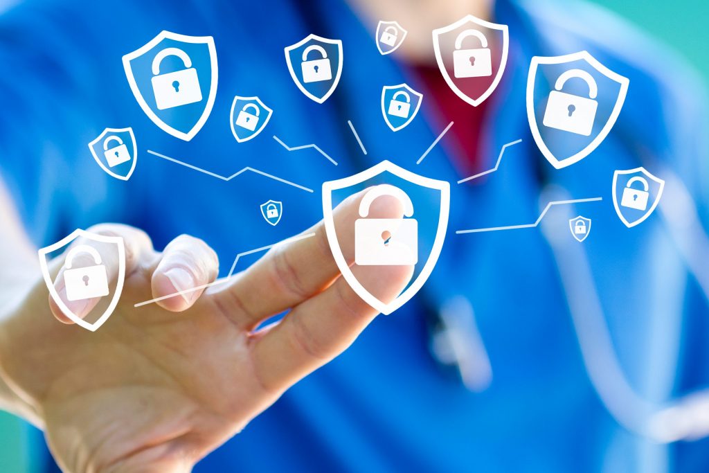 Close up of a healthcare worker in blue scrub’s finger reaches out to press one of many graphics of padlocks. 