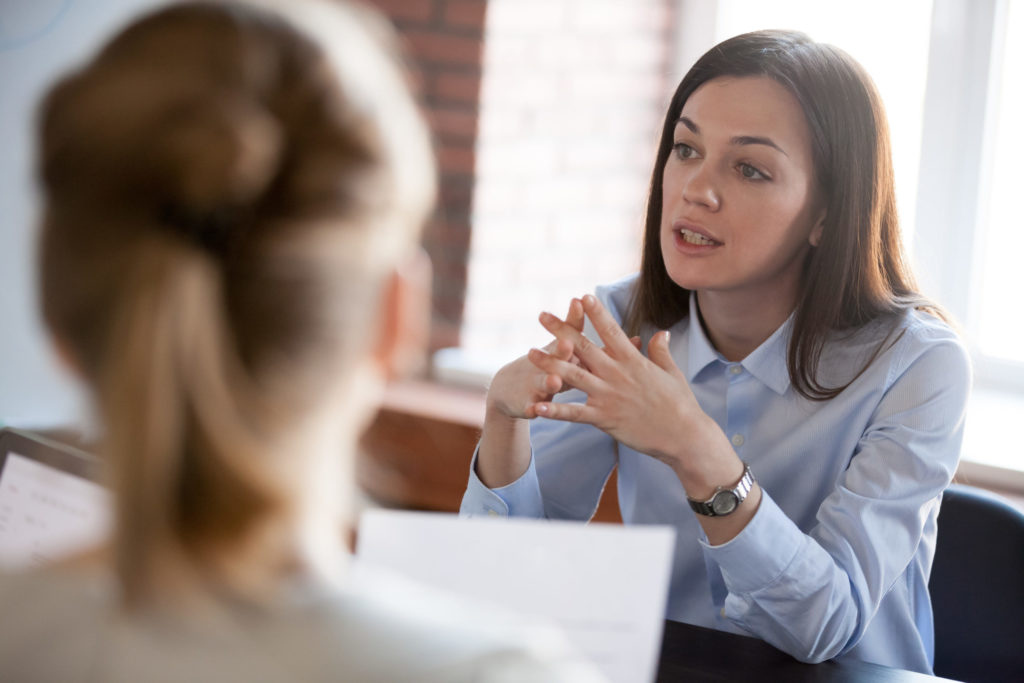 Confident business person explains cyber risk to clients. 