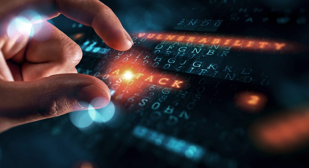 Close up of a finger tapping a screen showing blue code that’s become infected and turned red.