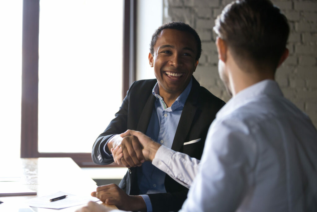  An insurance agent shakes hands with a business client.