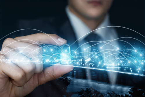 Close up of a businessman in a suit holding a blue holograph of a locked padlock between his index finger and thumb.