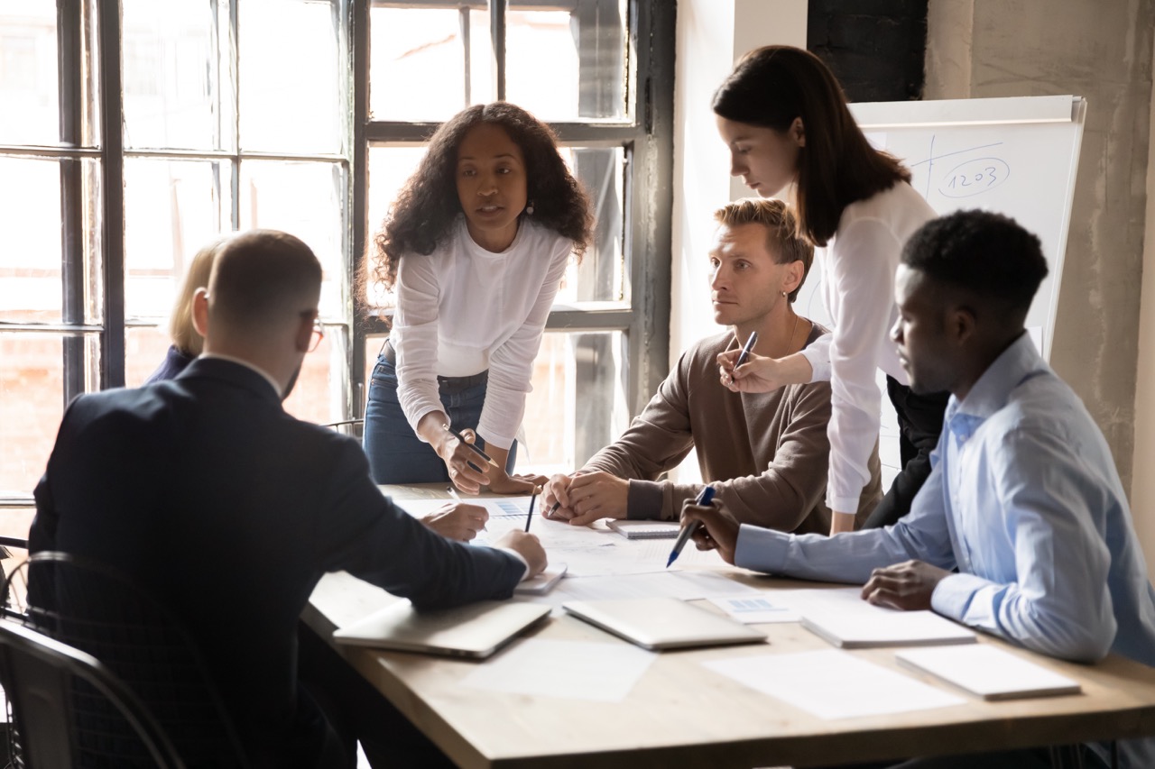 Company staff meet in the office for a post-breach analysis and to form an Incident Response Team.