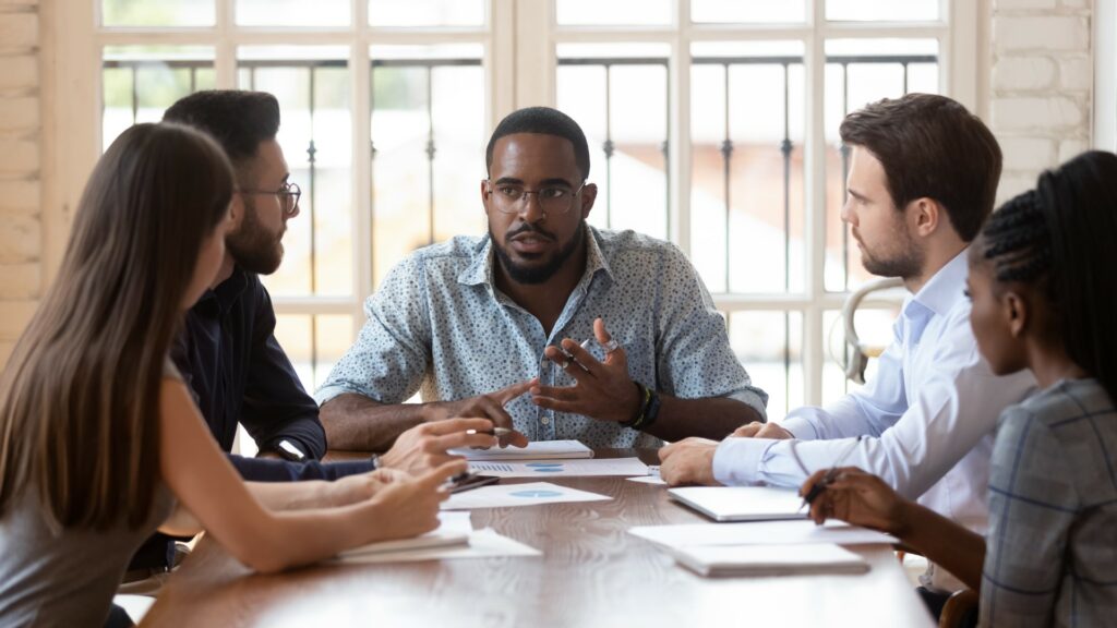 African American businessman goes over Cyber Insurance requirements with staff.