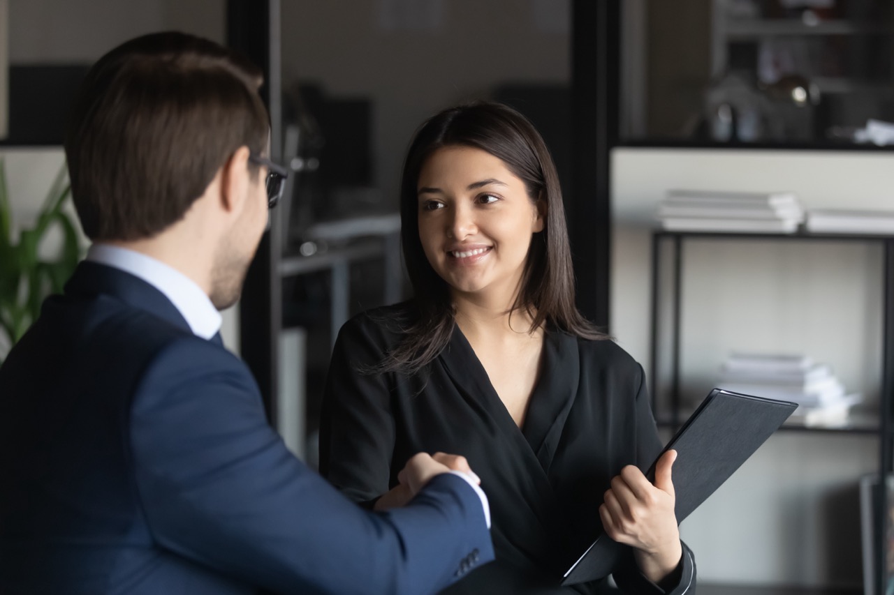 Cyber Insurance broker shakes hands with business client after she has sold him a Cyber Liability Insurance policy.