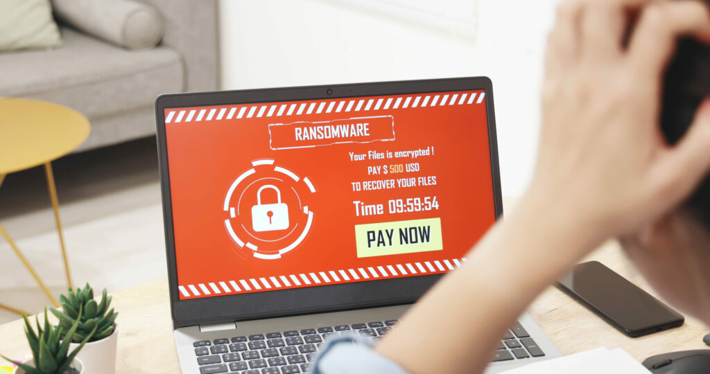 Worried person discovers ransomware on their laptop.