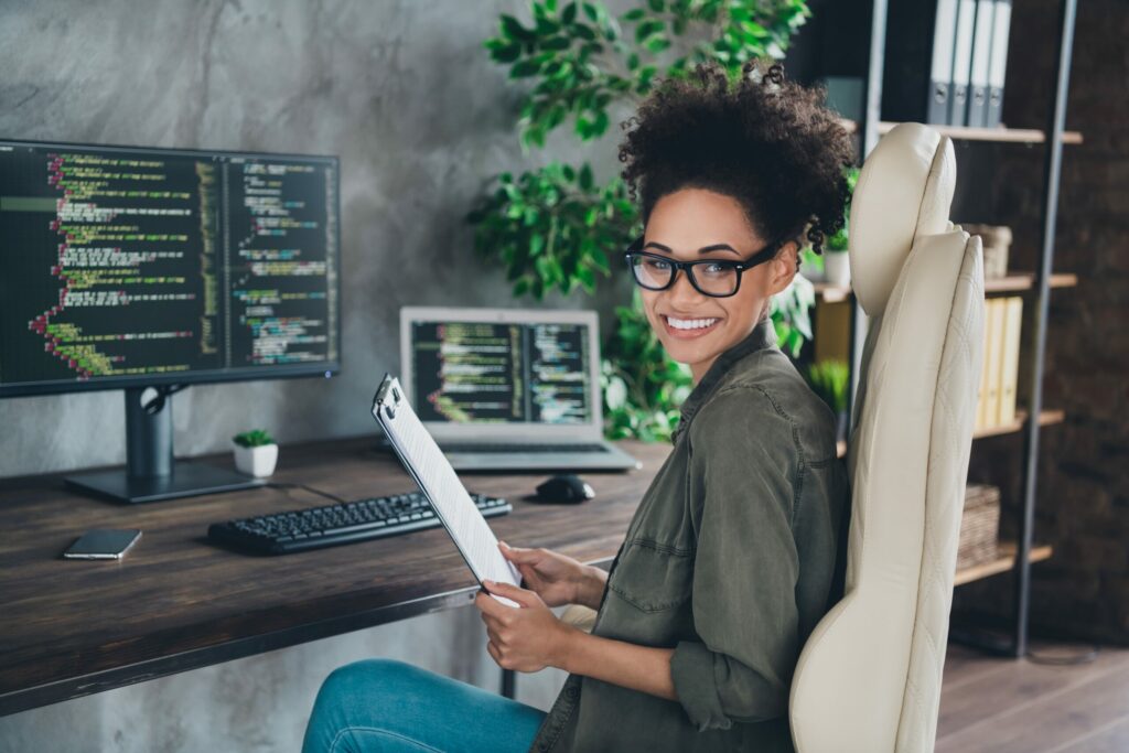 A young woman works from home at her desk.