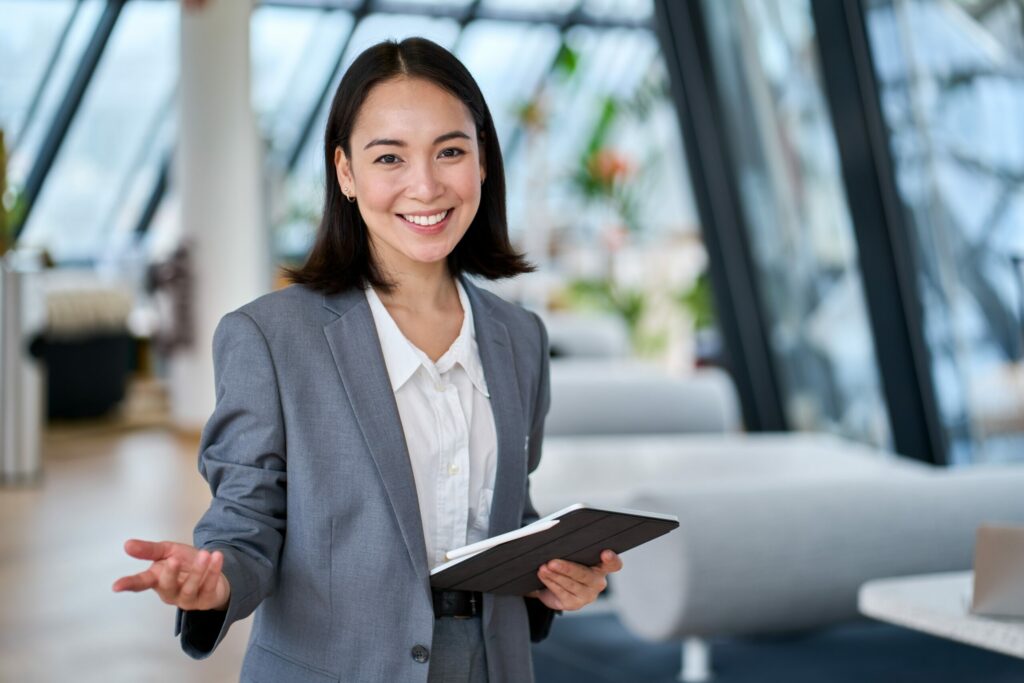 Portrait of smiling Cyber Insurance agent holding clipboard.