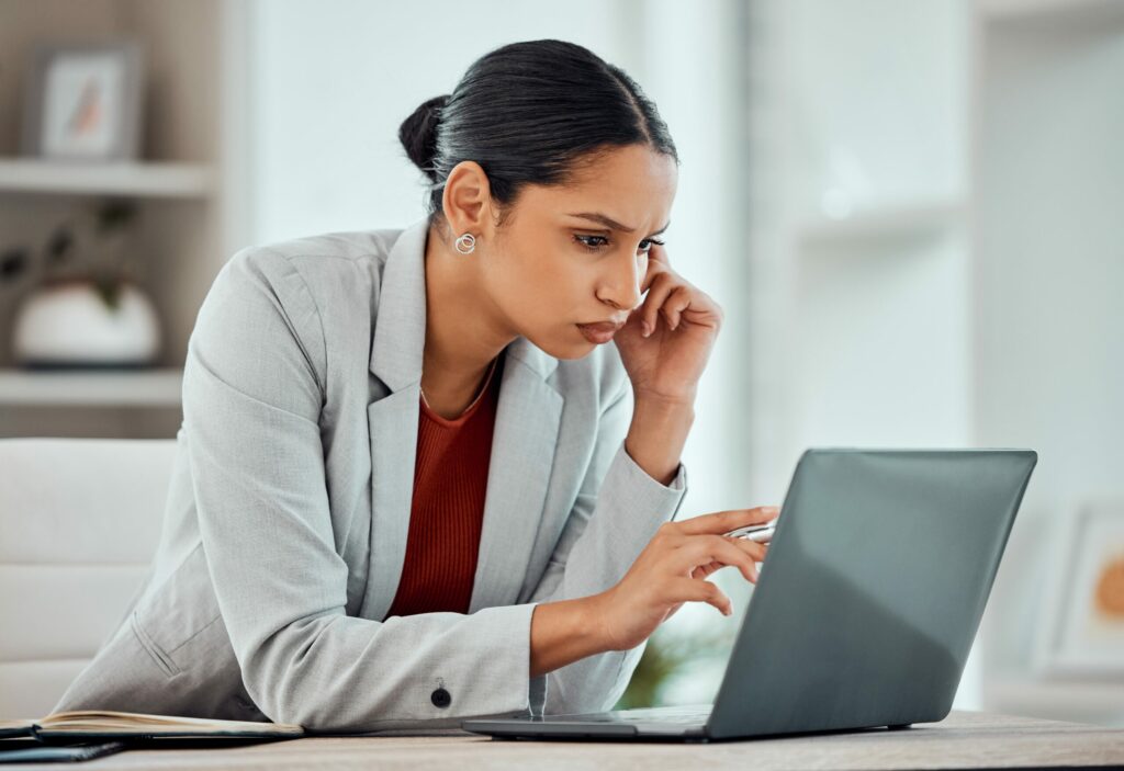  Businesswoman uses laptop computer on her desk to read email received via secure email gateway, a key cyber security control.
