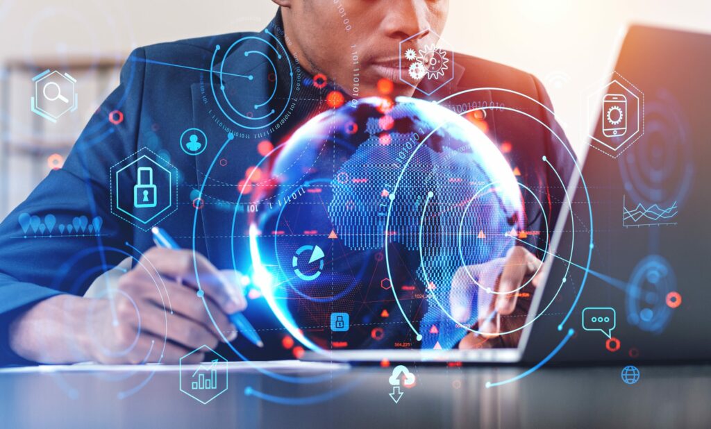 Insurance agent uses laptop computer to research Cyber Insurance coverage options for clients, security graphics overlaid.