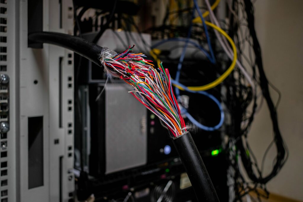 A common Cyber claim denial is the cost of repairing damaged computer equipment, illustrated by broken telecom cables.