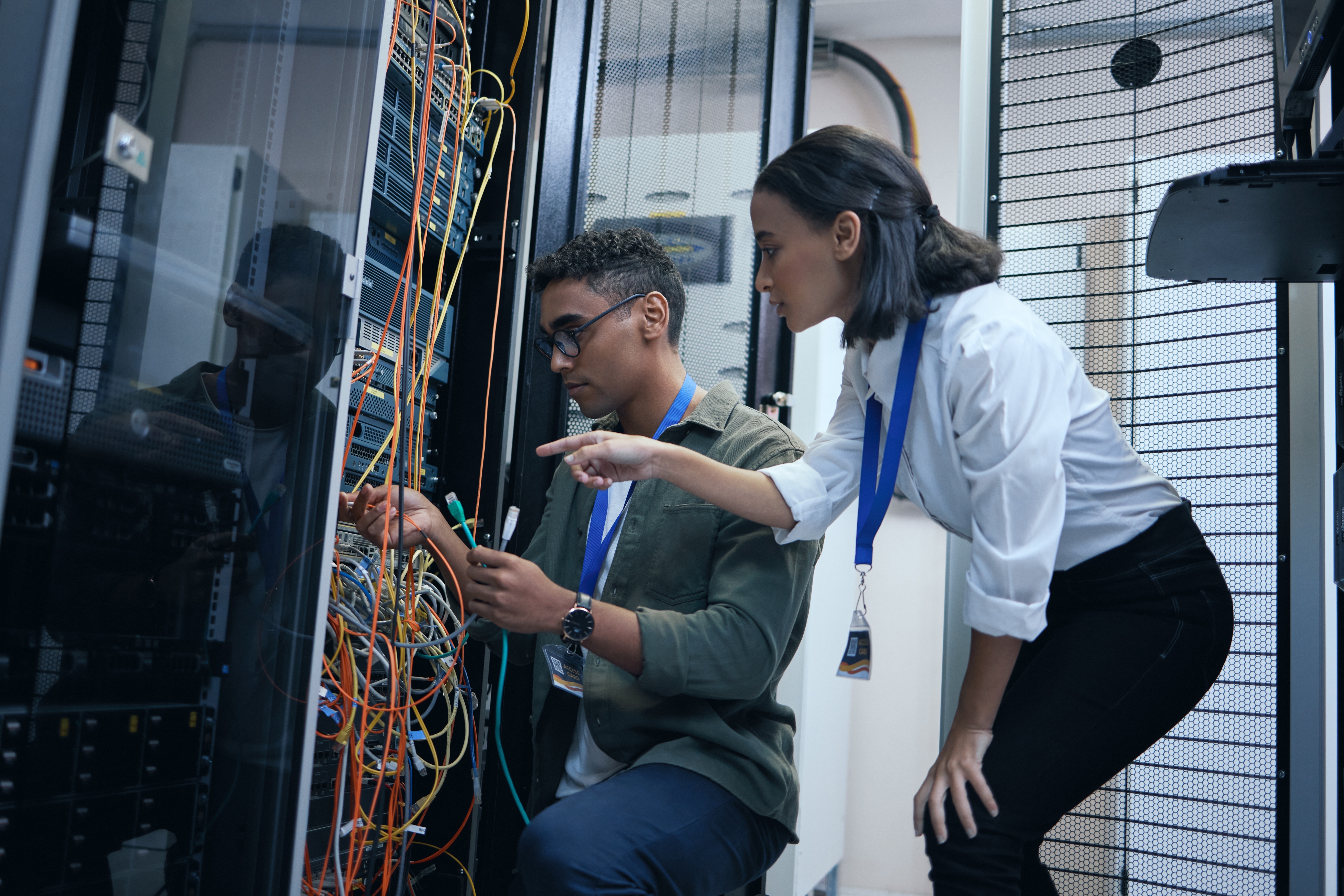 IT professionals discussing potential network vulnerability in server room.