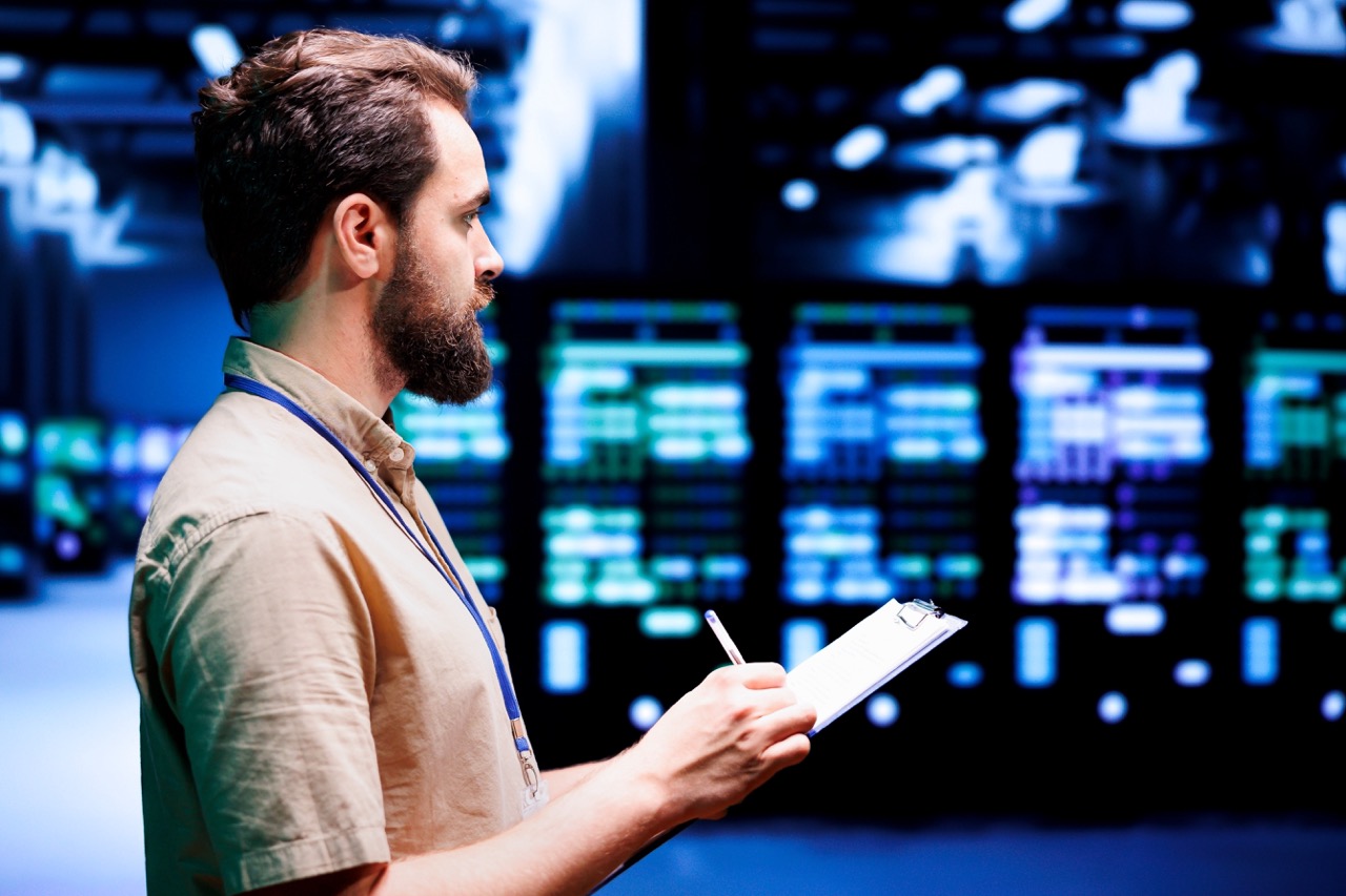 IT professional conducts cyber security audit in server room.