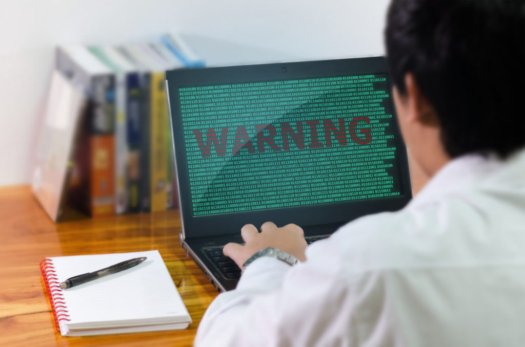  Man working on computer sees a warning message on the screen.