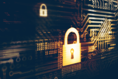Stylized padlock graphic on top of circuit board illustrates cyber security measures to stop and prevent DDoS attacks.