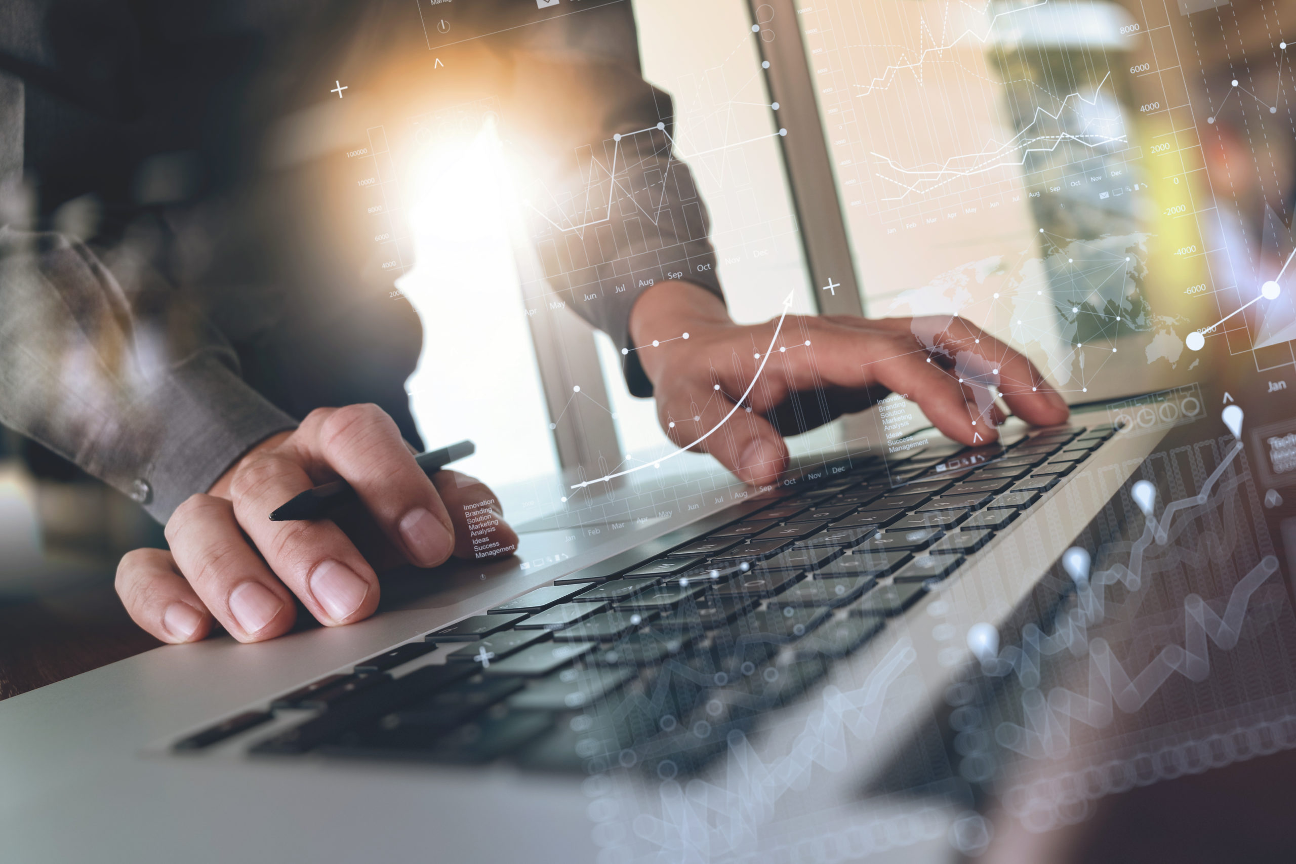 man working at a laptop with graphic overlay