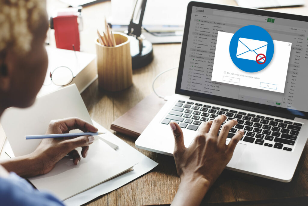 Businesswoman detects phishing emails while working from her laptop. 