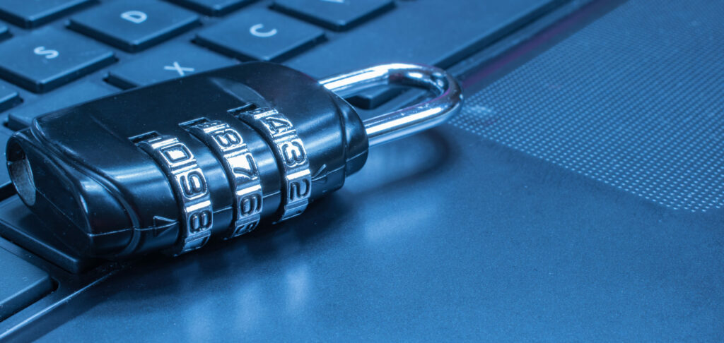 A combination lock rests on a computer keyboard.