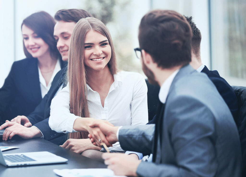Business client shakes hands with a Cyber Insurance agent after getting D&O coverage.