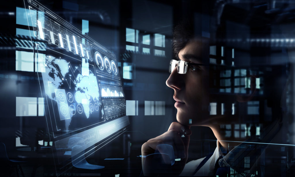  Member of computer forensics investigation team stares at world map on computer monitor, overlaid with other monitor images. 
