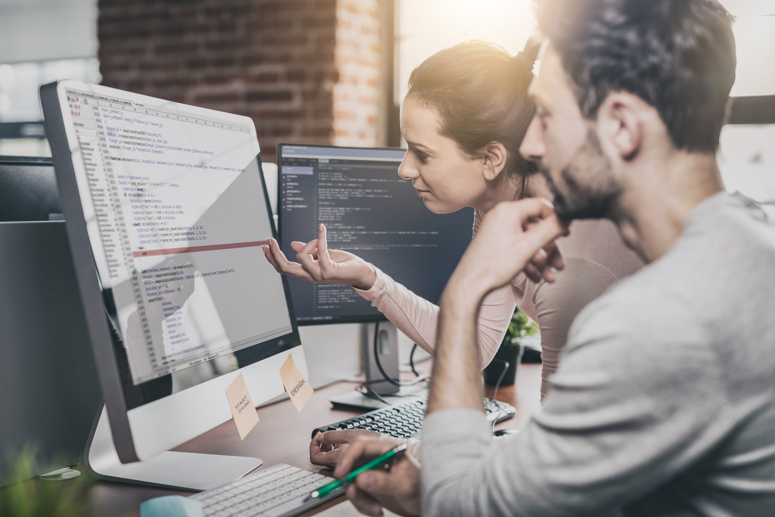 Cyber security professionals review code on a computer screen as they investigate a security break. 
